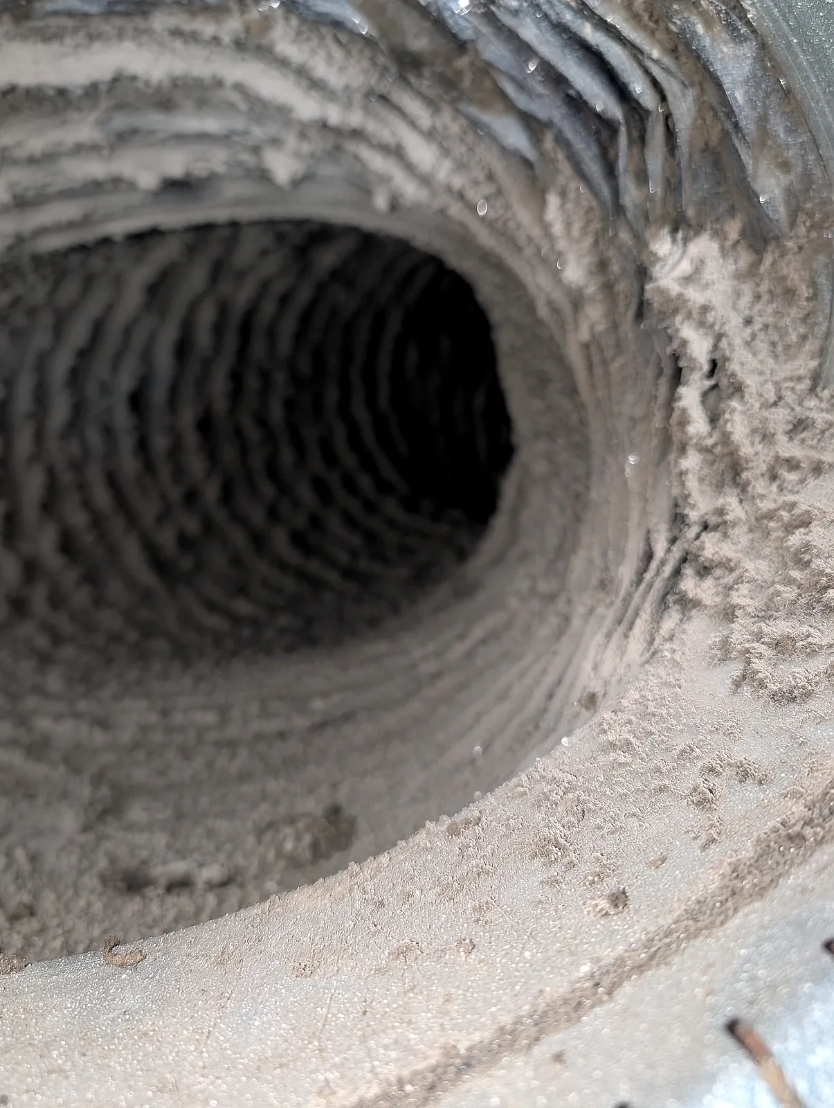 Inspection photo: heavy lint accumulation inside a flexible dryer vent